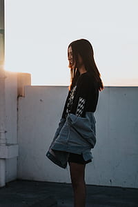 woman standing near wall smiling thumbnail
