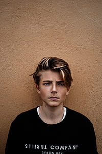 closeup photo of boy wearing black crew-neck shirt thumbnail