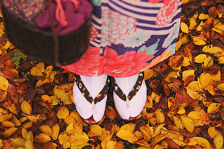 person wearing pair of black and red flipflops thumbnail