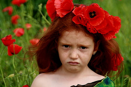 girl wearing red poppy flower hair accessory thumbnail