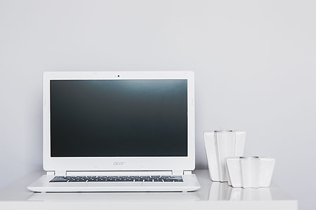 White laptop with smartphone and headphones thumbnail