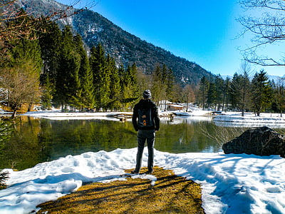 man standing in front of body of water at daytime thumbnail