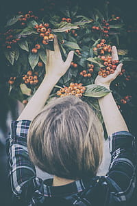 Woman Holding Orange Berries thumbnail