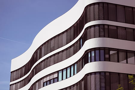white building with mirror curtain under blue calm sky thumbnail