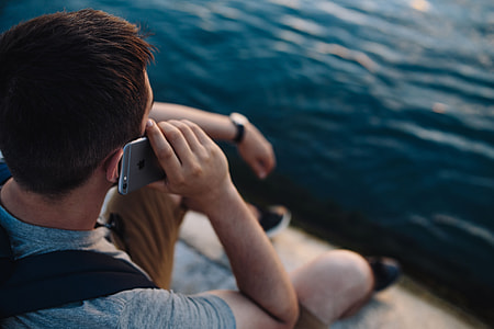 Mobile phone in man's hands near the sea thumbnail