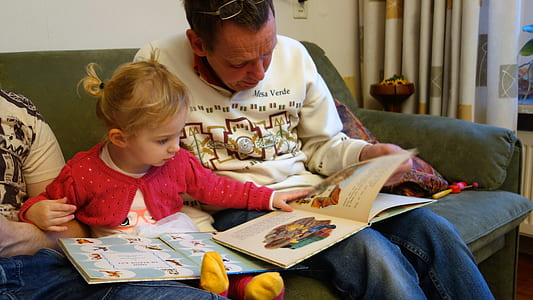 man and child reading books thumbnail
