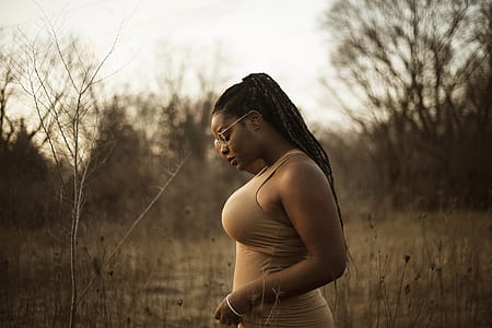 selective focus photograph of woman in brown tank top thumbnail