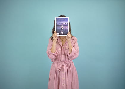 woman covering face with book thumbnail