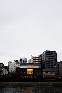 building near the ocean during day thumbnail