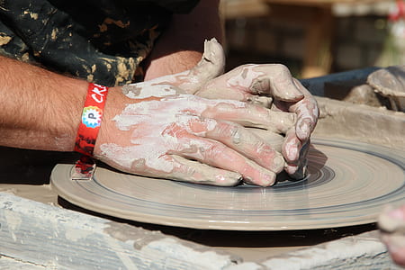 person molding pot on platform thumbnail