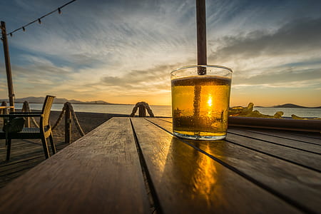 shot glass filled with beer on table thumbnail