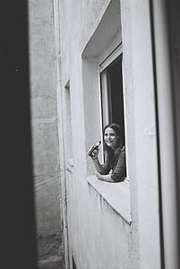 woman on window holding bottle thumbnail