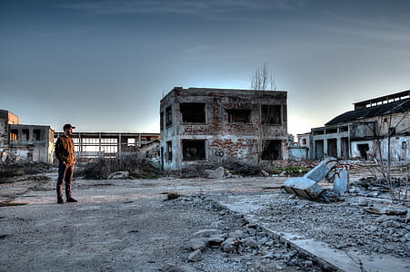 man standing near 2-story concrete building thumbnail