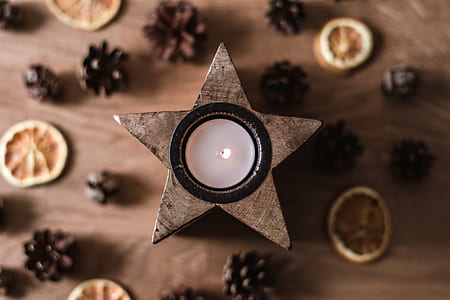 flat lay photography of brown star tealight candle thumbnail