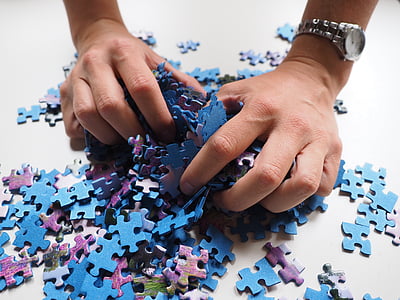 person picking jigsaw puzzles thumbnail