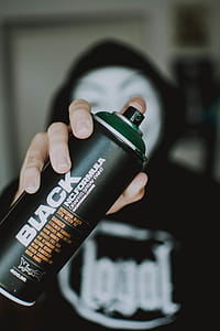 Person Holding Black Spray Bottle thumbnail