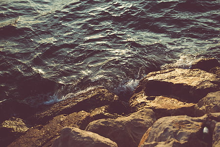 brown stones near body of water thumbnail