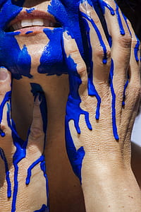 person's hands with blue paint thumbnail
