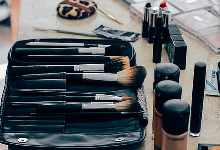 makeup brushes near bottles thumbnail