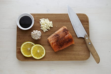 cooked fish on top of rectangular brown wooden board thumbnail