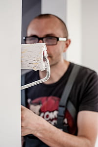 man using paint roller on wall thumbnail