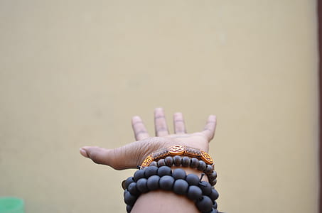 person wearing beaded black bracelets thumbnail