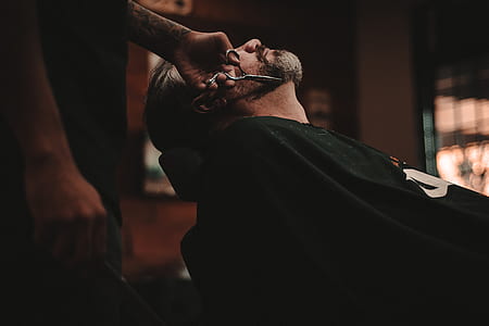 man cutting another man's beard thumbnail