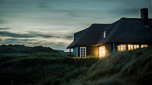 Gray House With Fireplace Surrounded by Grass Under White and Gray Cloudy Sky thumbnail