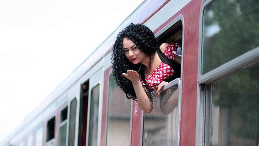 woman doing flying kiss on vehicle window thumbnail
