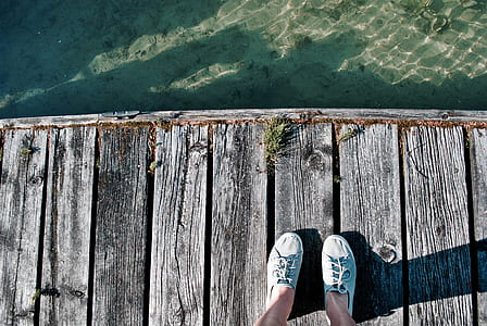 person standing near body of water at daytime thumbnail