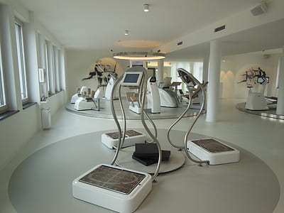 three white-and-silver exercising machines inside building thumbnail