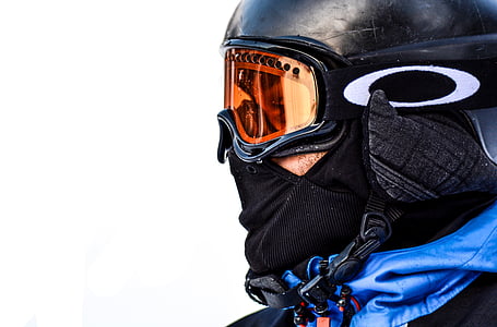 person wearing orange Oakley snow goggles with black frame thumbnail
