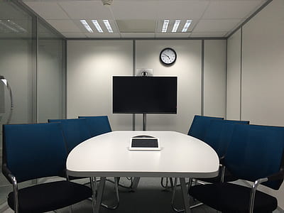 white wooden table and six blue armchairs in room thumbnail