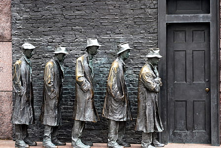 five men statue lining up near door photo thumbnail