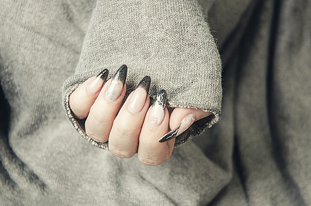 photograph of person with black manicure thumbnail