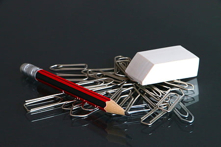 red and black pencil with eraser and gray paper clips on focus photo thumbnail
