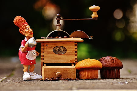 selective focus photography of person beside grinder with cupcakes thumbnail