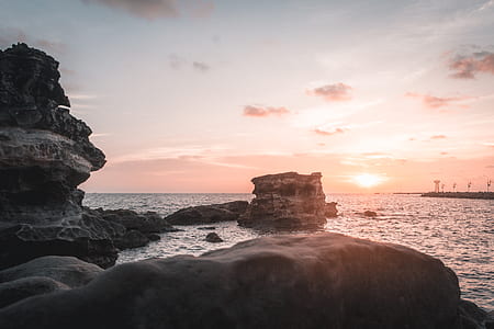 landscape photography of rocks in shore thumbnail