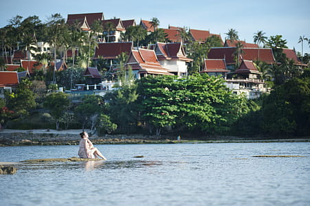 Woman on Rock Beside Body of Water thumbnail