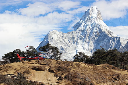 mountain peak near green leafed trees thumbnail