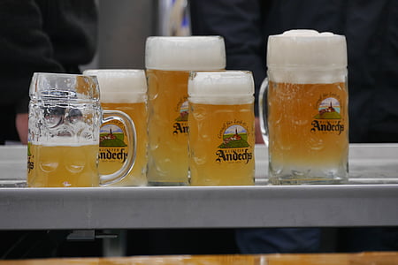 five clear glass beer mugs with liquids thumbnail
