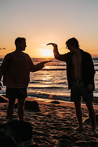 two men standing on seashore thumbnail