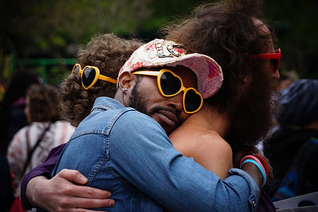 man hugging man during daytime thumbnail