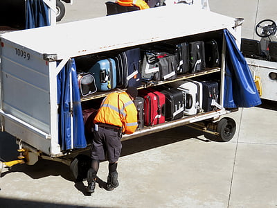 man standing beside file of luggage bag thumbnail