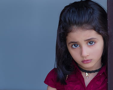 girl wearing red button-up top and black choker necklace standing inside well lighted room thumbnail