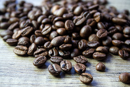 macro photography of brown coffee beans on brown mat thumbnail