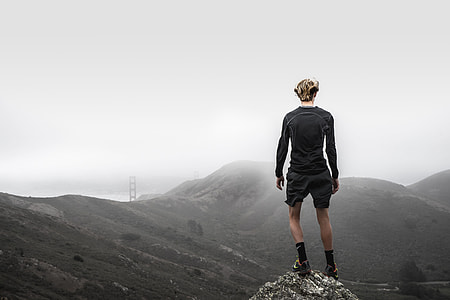 man standing on summit of mountain thumbnail