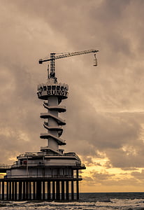 photography of white and gray crane on spiral tower beside body of water at daytime thumbnail