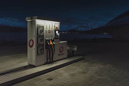 white fuel dispenser near bodies of water at night time thumbnail