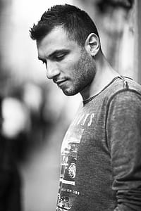 grayscale photo of man wearing crew-neck top thumbnail